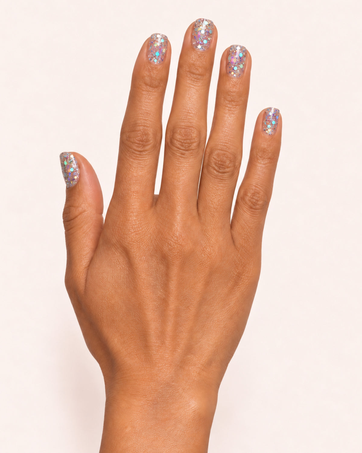 Mayvee nail polish in 'Blame The Moon' silver holographic glitter nail colour on medium skin tone