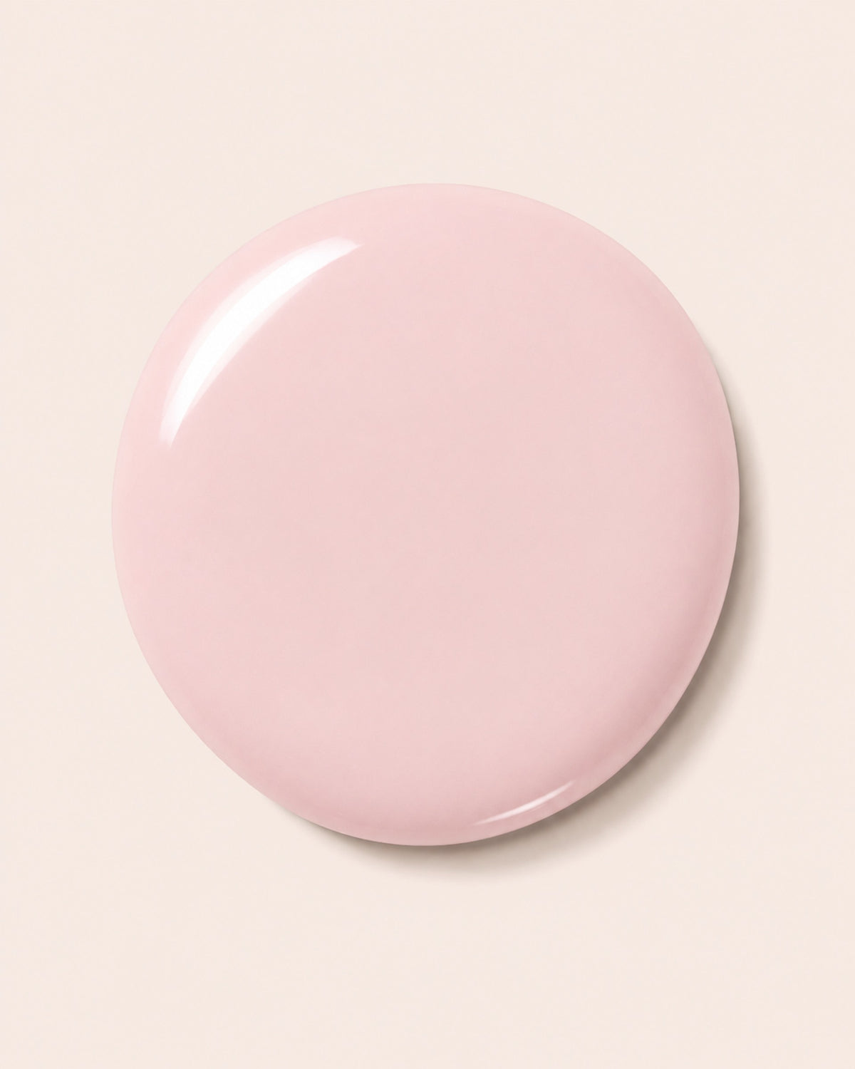 Pink nail polish bottle cap with glossy finish