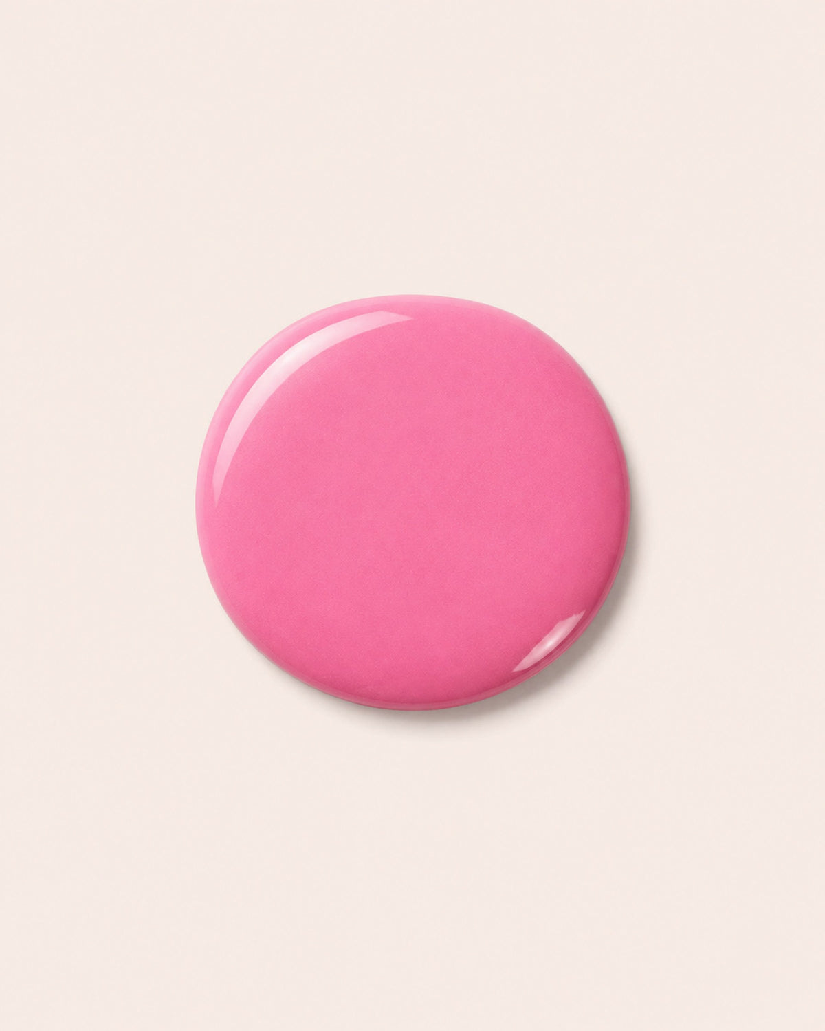 Round pink nail polish cap with glossy finish