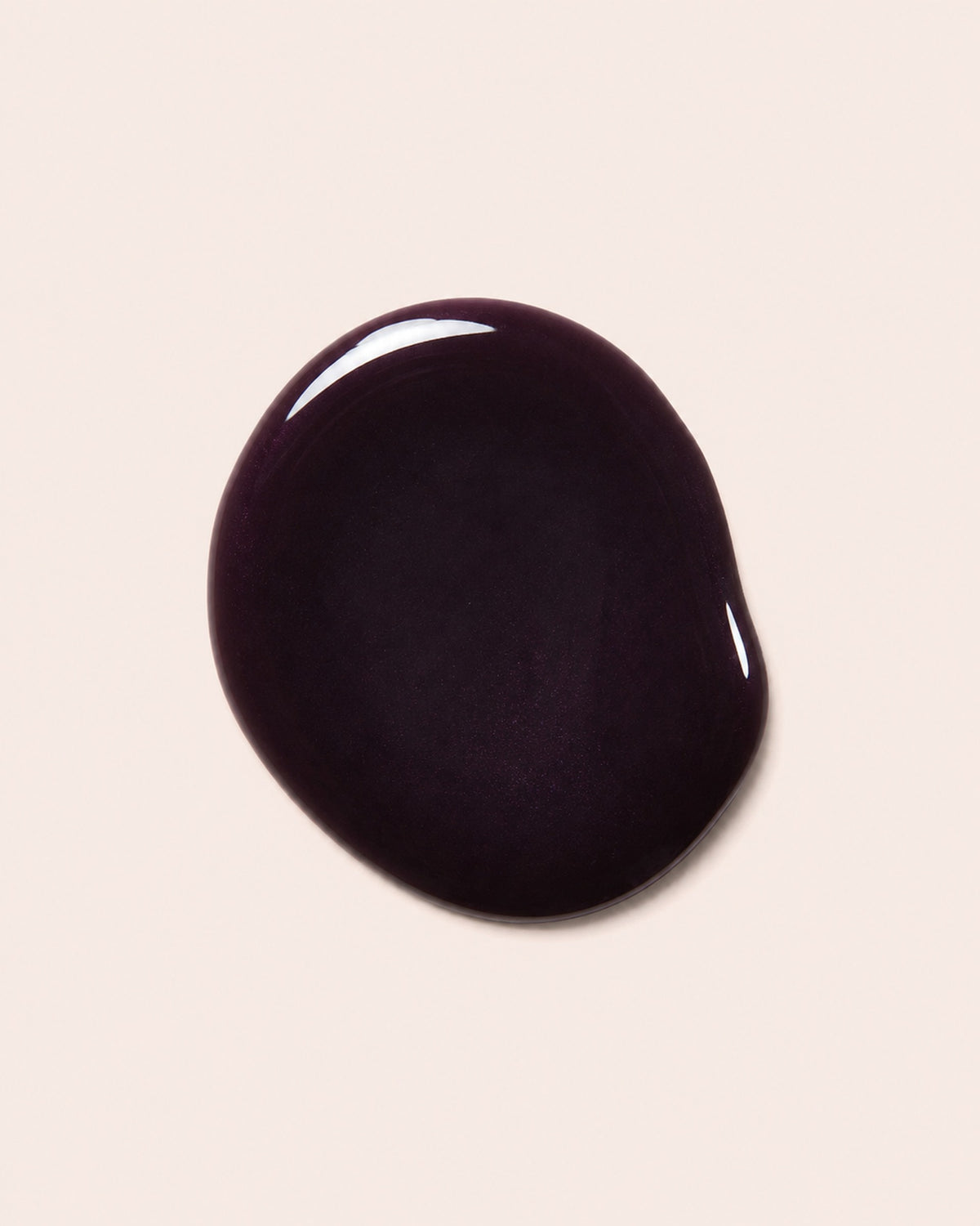 Dark maroon nail polish bottle cap with glossy finish