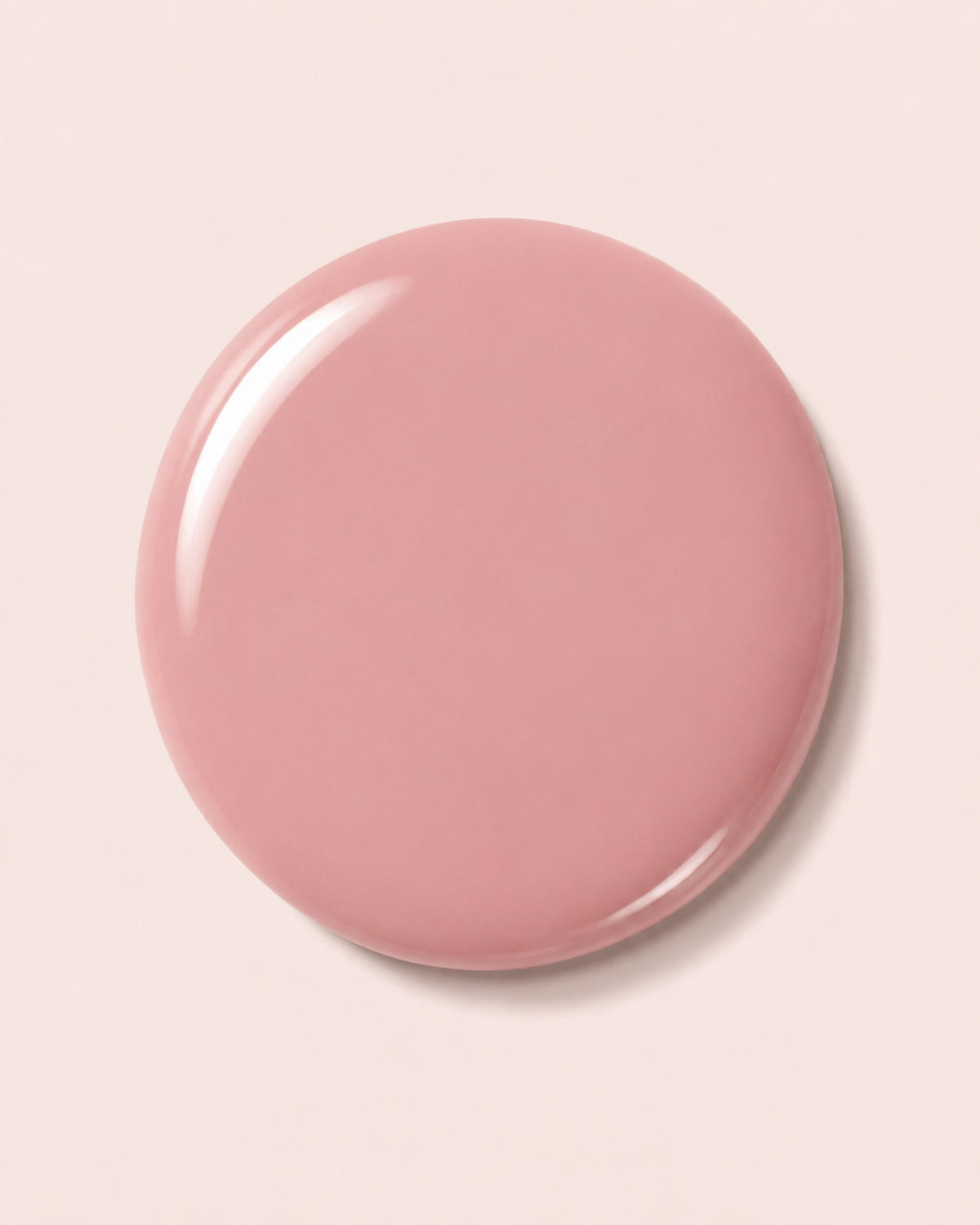 Glossy pink nail polish swirl on round cap