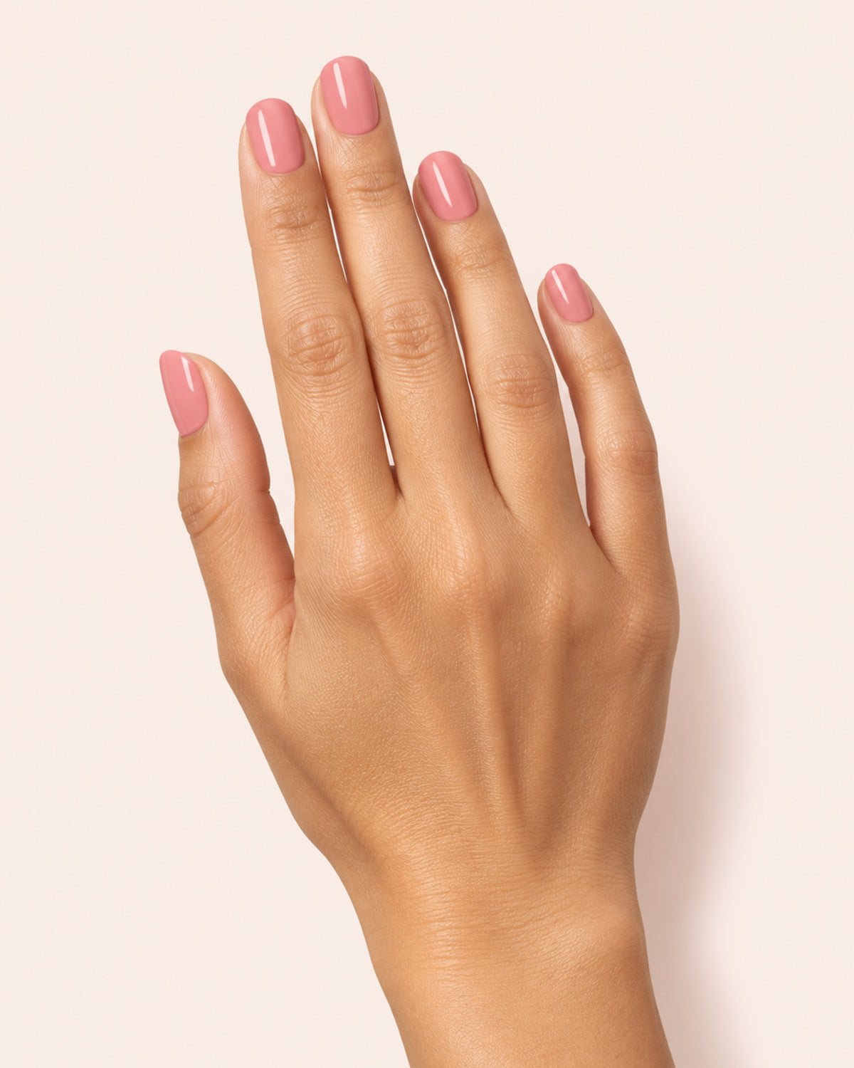 Mayvee nail polish in 'Too Pretty To Rush' pink creme nail colour on olive skin tone