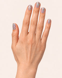 Mayvee nail polish in 'Blame The Moon' silver holographic glitter nail colour on light skin tone