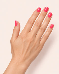 Mayvee nail polish in 'Born Like This' fluro pink creme nail colour on fair skin tone