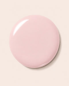 Pink nail polish bottle cap with glossy finish
