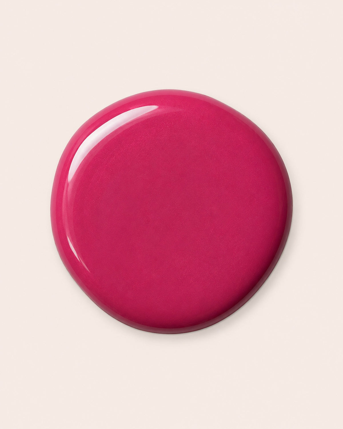 Fuchsia pink nail polish cap close-up with glossy gel-like look