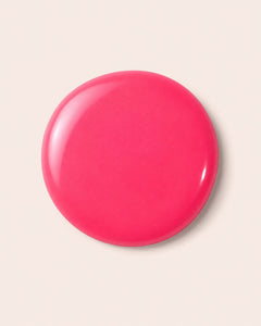 Fuchsia nail polish swirl cap top, glossy circular surface
