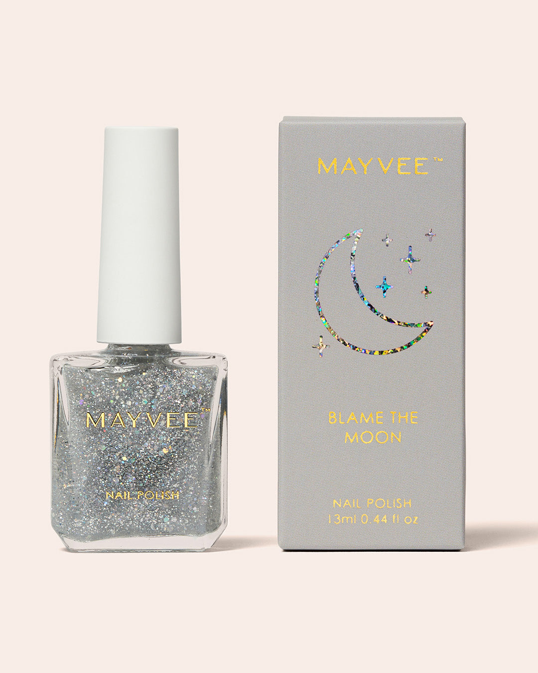 Silver holographic glitter nail polish bottle with box MAYVEE brand, 13 ml in 'Blame The Moon' with moon and stars icon in holographic print detail on box
