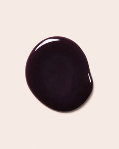 Dark maroon nail polish bottle cap with glossy finish