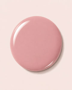 Glossy pink nail polish swirl on round cap