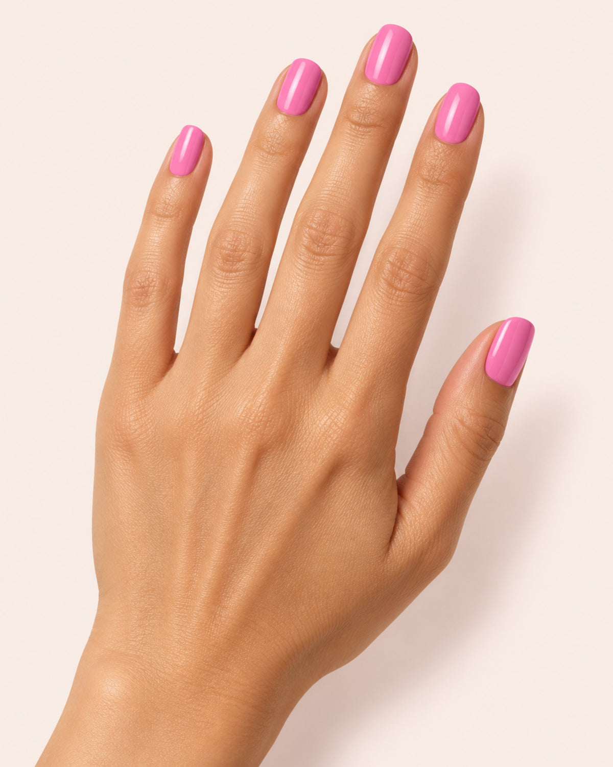 Mayvee nail polish in 'My Own Lane' bright pink creme nail colour on medium skin tone