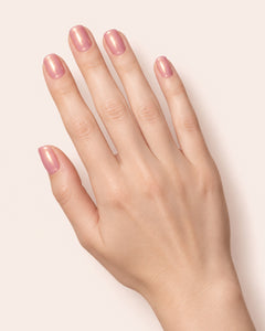 Mayvee nail polish in 'The Stars Were Right' pink and gold shimmer nail colour on fair skin tone